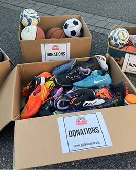 Volunteer loading donated gear into a car — gear drives